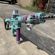 Unicorn Ar-15 rifle with custom Cerakote, laser engraving, and holosun optic.