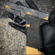 Black and Gold Glock G43x with custom Cerakote, laser engraving, stippling. Best Custom Gun Shop.